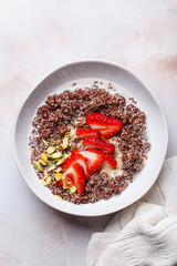 Breakfast quinoa bowl with strawberries and pistachio.
