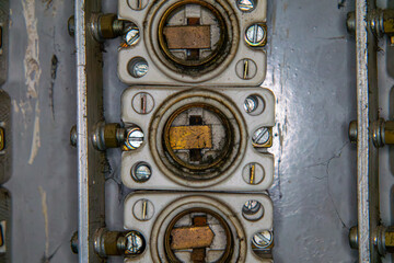 old fuse box. old electrical installation in an electrical cabinet. small and large fuses. electric cables.