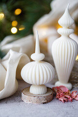 Luxurious handmade soy wax candle in cozy room, Christmas lights in the background