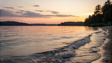 Obraz premium Soft focus photography of a serene lake scene with gentle waves lapping against the shore at sunset, natural light, peaceful atmosphere, lake scenes, sunset colors