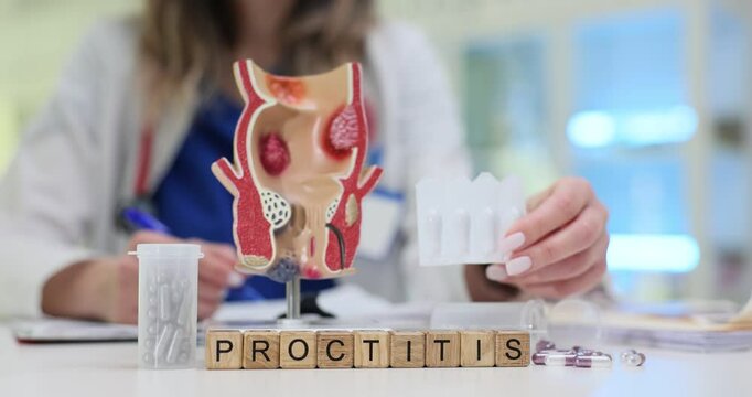 A healthcare professional carefully examines a detailed model that illustrates various conditions related to proctitis