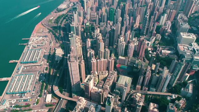 HONG KONG, CHINA - FEBRUARY 2, 2025: Vibrant city landscape featuring skyscrapers and harbor views from above during a clear afternoon