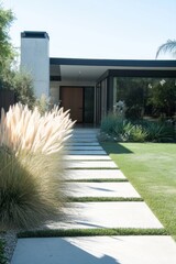 Obraz premium A sleek and modern architectural pathway guides visitors to a striking contemporary home, beautifully enveloped by vibrant greenery and abundant natural light
