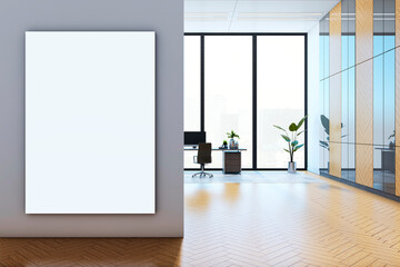 Modern office interior with large vertical canvas on a wall and workspace in the background. 3D Rendering