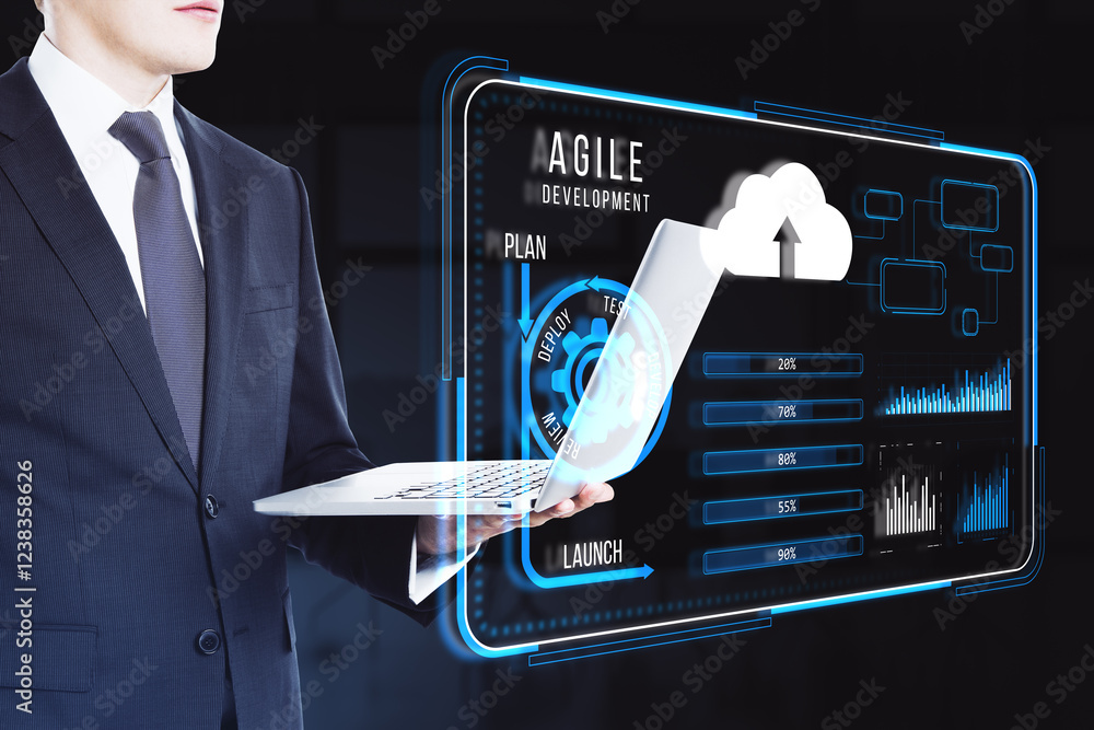 Aufkleber Businessman with laptop and virtual agile development interface display on dark background.