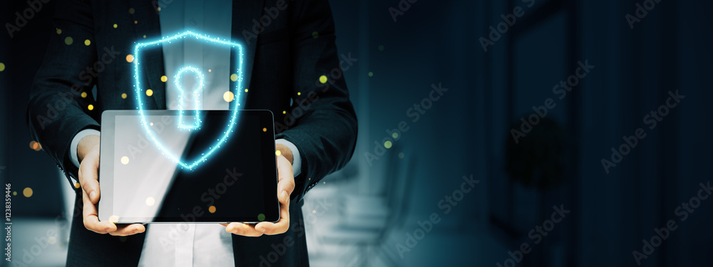 Poster businessman holding a tablet displaying a glowing shield with a keyhole symbol, representing cyberse