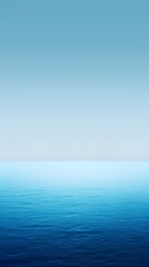 Obraz premium A blue ocean with a clear sky in the background