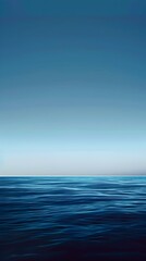 Fototapeta premium A blue ocean with a clear sky in the background