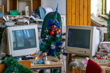 abandoned office in an old production plant. old computers and computer monitors. piles of...