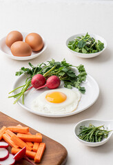 Fried egg with radish and vegetables for breakfast