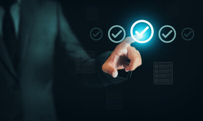 Obraz premium Man touching the Checklist with white tick marks inside circles, glowing blue light. Ticking items on the checklist concept design, backdrop