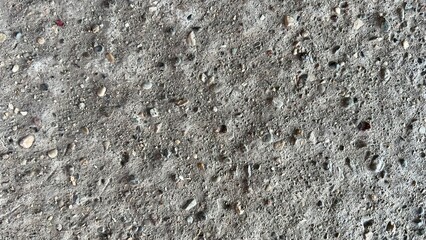 Surface texture of concrete showing various stones and pebbles