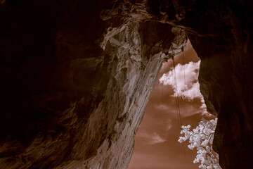 Infrared photography, a rocky, cavernous area with textured stone walls