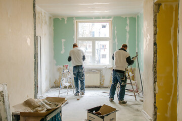 Internal repair of the apartment. worker performs rough work