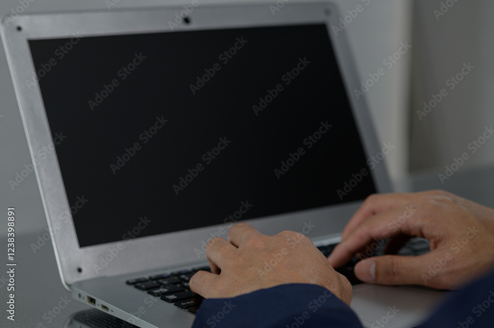 Poster hands typing on laptop keyboard with blank screen background