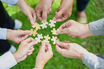Teamwork Coworker's hand holding jigsaw puzzle With the cooperation of business people join...