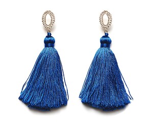 Pair of blue tassel earrings with gold studs on a white background.