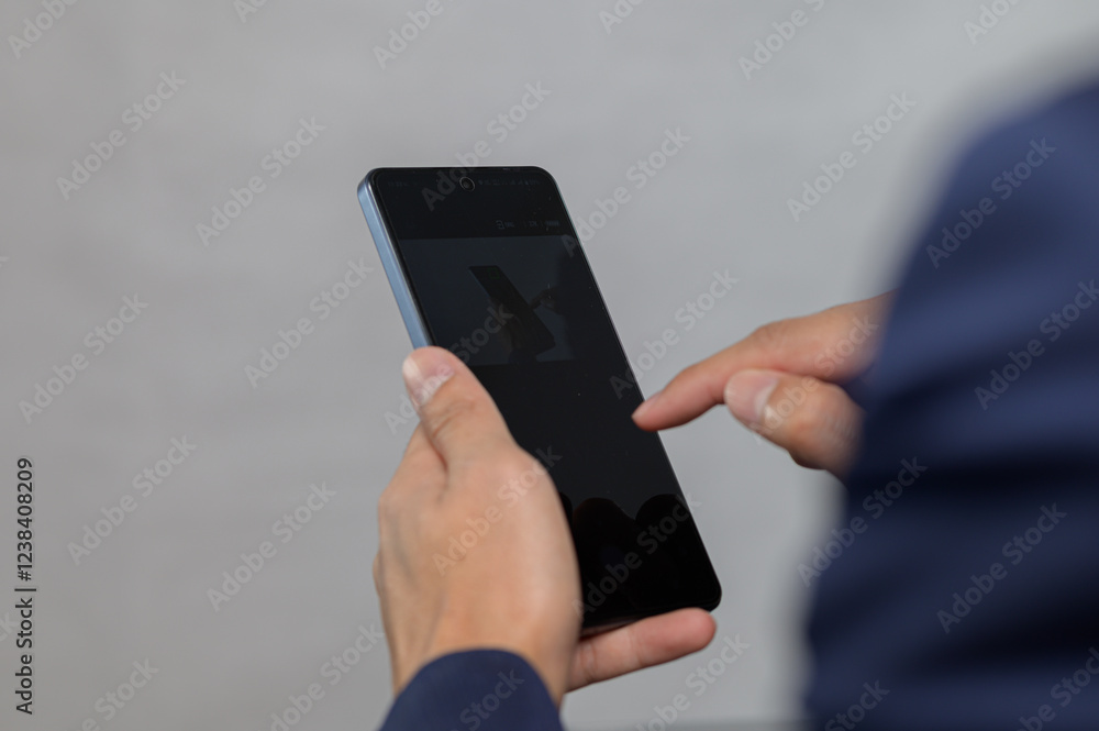 Poster person using smartphone with focus on touchscreen interaction