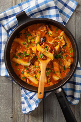 Traditional Korean Tteokbokki rice noodles with chicken, vegetables and shitake mushrooms. Prepared in a pan.