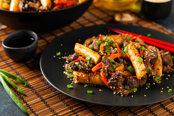 Traditional Korean Tteokbokki rice noodles with beef, vegetables and shitake mushrooms. Prepared in a wok.