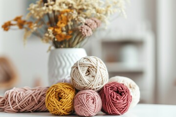Knitting. Balls of cotton and wool yarn in warm tones on a white table. Boho, bed tones, orange, pink, turquoise, hobby