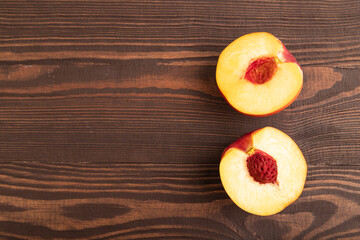 Peach Cut in half on brown wooden, Top view, copy space