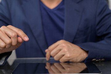 Close-Up of Businessman Touching Tablet Screen in a Modern Setting