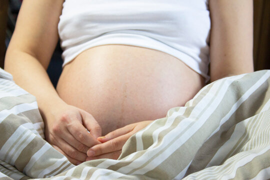 Pregnant woman relaxing in the bed