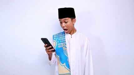 handsome young muslim asian man shocked expression gesture looking and holding mobile phone with isolated white background