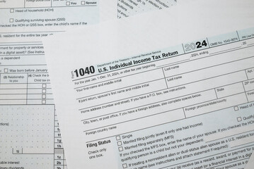 Obraz premium us tax forms 1040. 2024 year, business tax time concept.