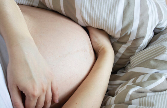 Pregnant woman relaxing in the bed