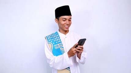 handsome young muslim asian expression smiling gesture looking and holding mobile phone with isolated white background