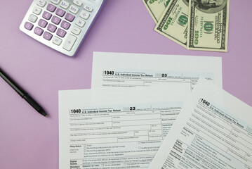 1040 tax form 2023 . Tax return forms 1040 with office supplies and dollar bills. Time to pay taxes.