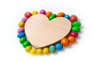 Obraz premium Colorful bead heart craft. Craft showcases a wooden heart adorned with vibrant colored beads, perfect for creative projects or decor.