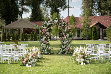 Wedding ceremony. Very beautiful and stylish wedding arch, decorated with various fresh flowers,...