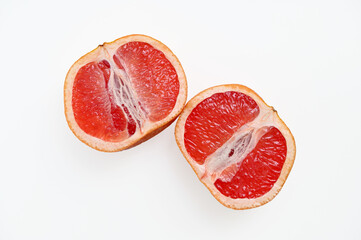 cut grapefruit two halves isolated on white background