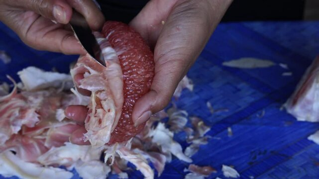 Easy way to peel red pomelo with a knife