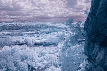 A breathtaking infrared photograph captures a dramatic landscape of a vast
