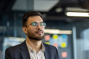 Businessman in jacket close up breathing and resting relaxing, man with closed eyes at workplace inside office wearing glasses.