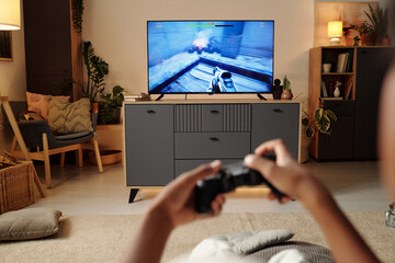 Enjoying Evening Playing Video Game in Cozy Living Room