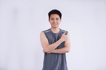 Fototapeta premium Image of an Asian guy wearing gym clothes posing on a white background