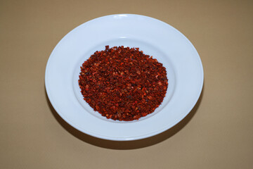 seasoning for food. dried paprika, chili pepper close-up in a white plate