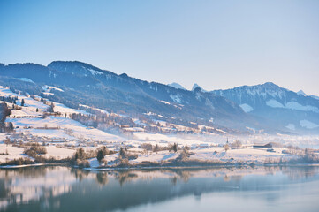 Winter landscape of Lake Gruyere covered with snow