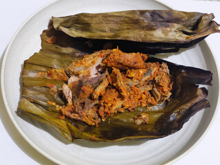 Pepes ikan, pepes ikan is a traditional Indonesian dish made from fish mixed with chili sauce wrapped in banana leaves and grilled.