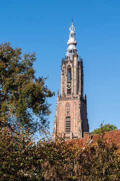 The tall Tower of Our Lady in the historic town center of Amersfoort on a sunny day in autumn in the Netherlands.
