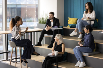 Young African woman lead formal meeting with colleagues, discuss project strategy, solutions,...