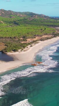 Aerial drone view on white sand Berchida beach of Sardegna. Warm turquoise sea and long beach on the Sardinia island.