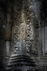 Intricate stone carvings on Angkor Wat temple wall.