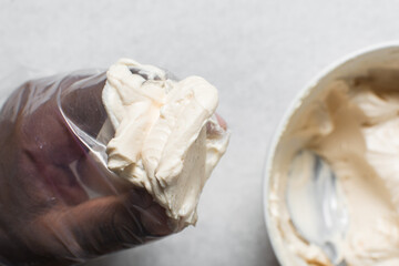 Putting Buttercream into a piping bag, American buttercream in a piping bag for icing cake,...