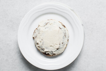 Overhead view of vanilla frosting coated cookies, top view of vanilla cookies with a vanilla cream frosting, process of making bakery style cookies